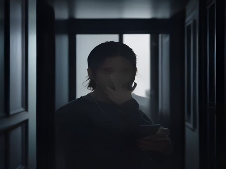 A cinematic, photorealistic 8k image showing a stressed tenant looking at a smartphone screen with a blurred background of an apartment complex, capturing the anxiety and uncertainty of a crumbling housing rental market with a dark, moody atmosphere.